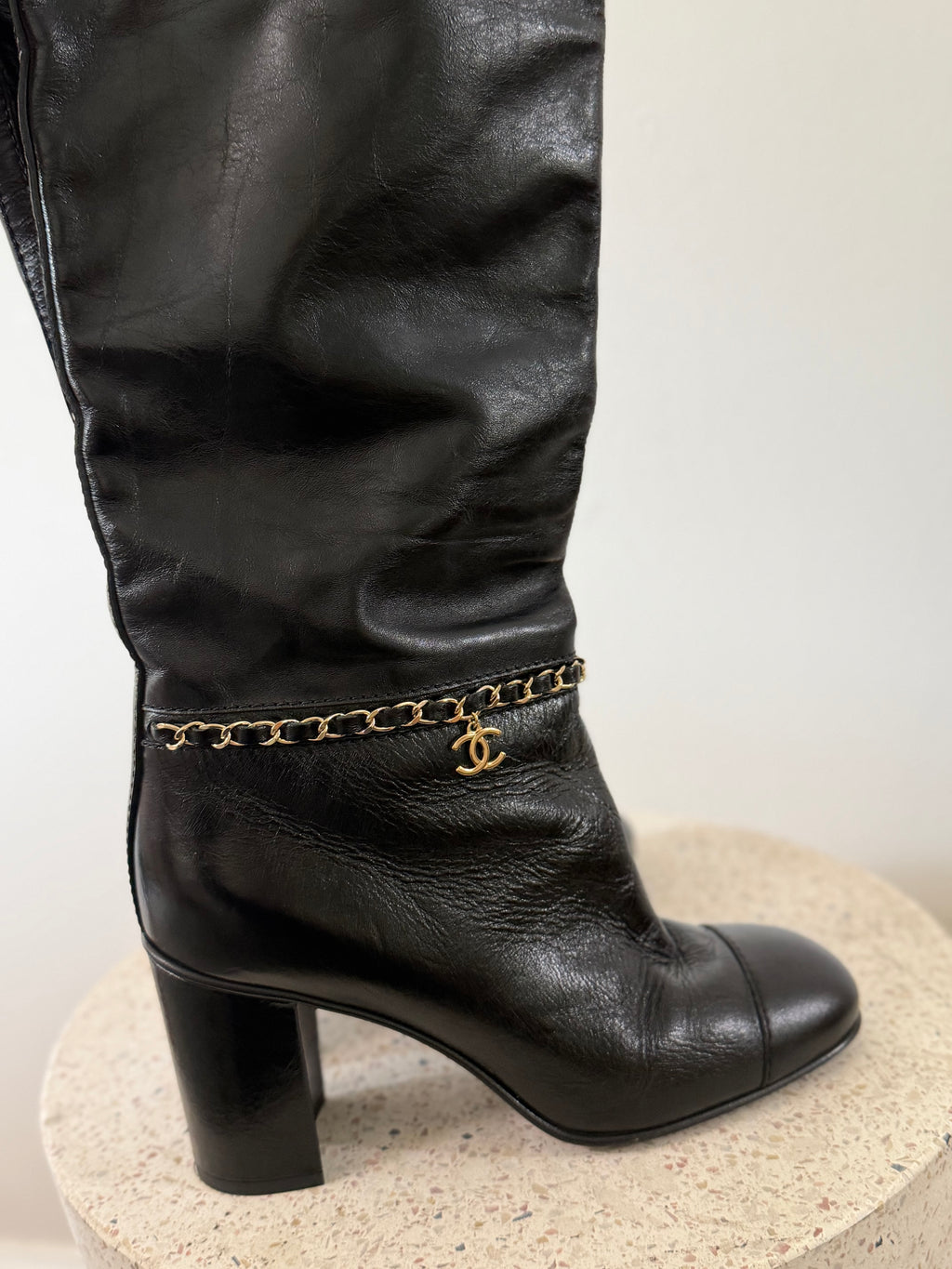Chanel leather tall boots with a gold CC chain detail and block heel