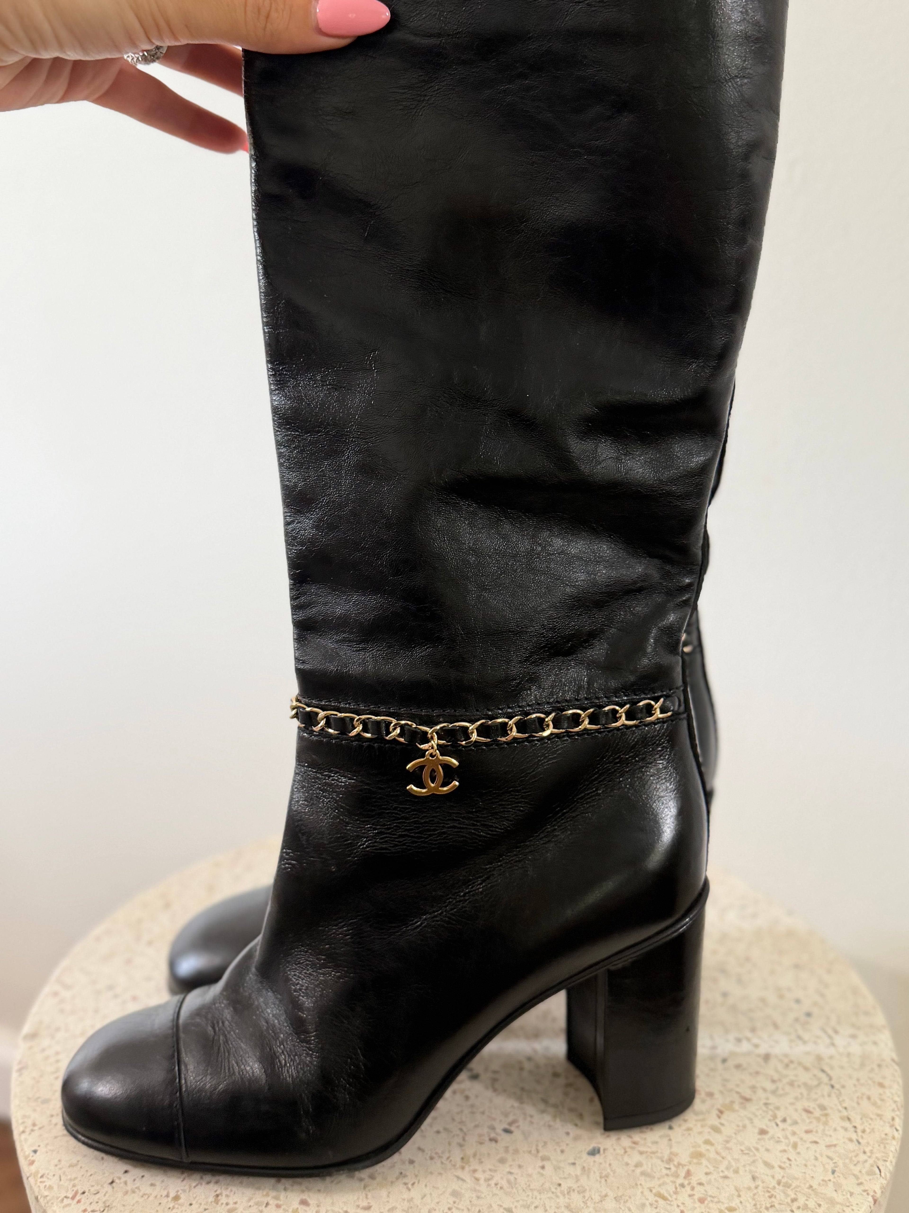 Chanel leather tall boots with a gold CC chain detail and block heel