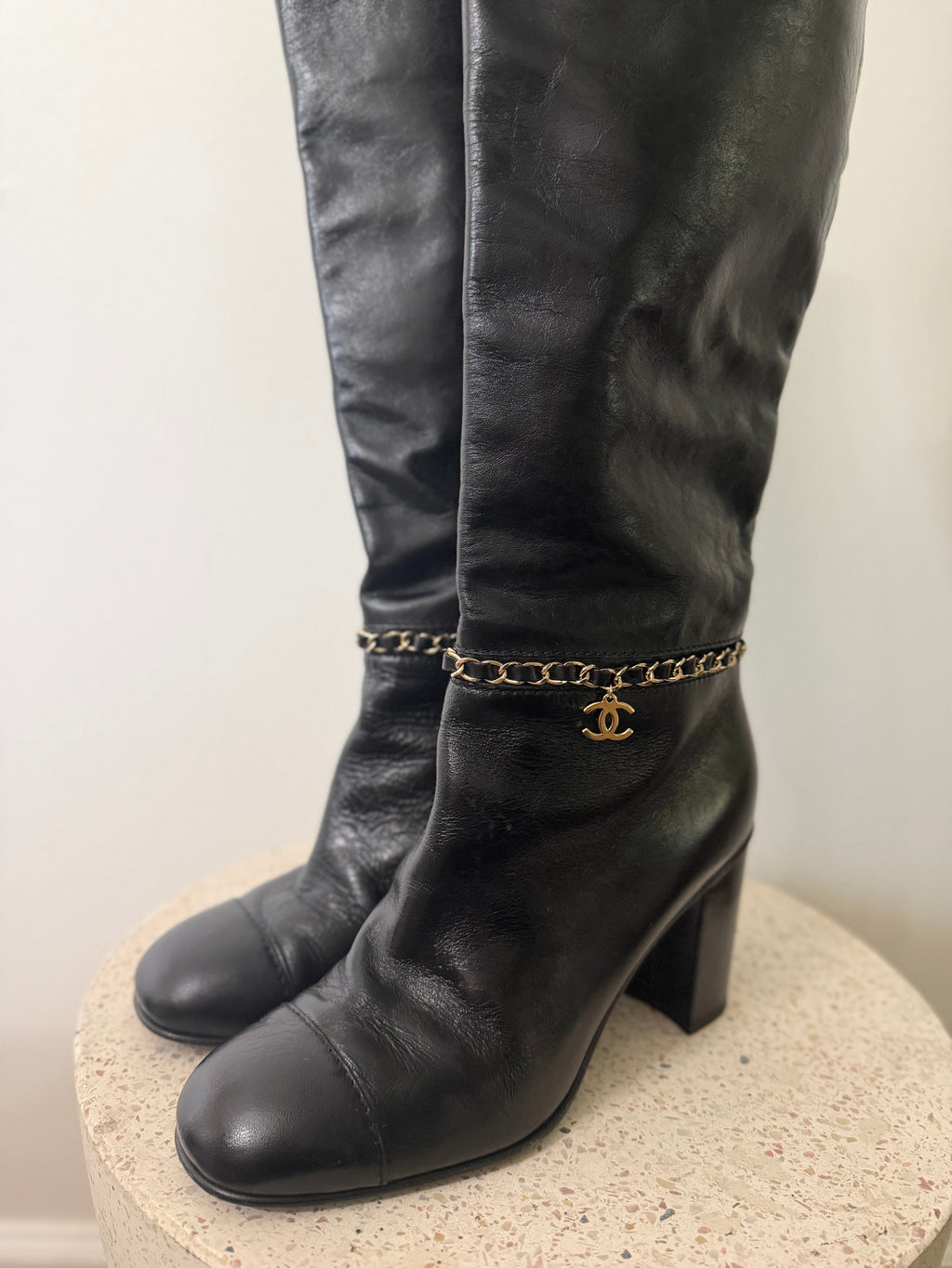 Chanel leather tall boots with a gold CC chain detail and block heel