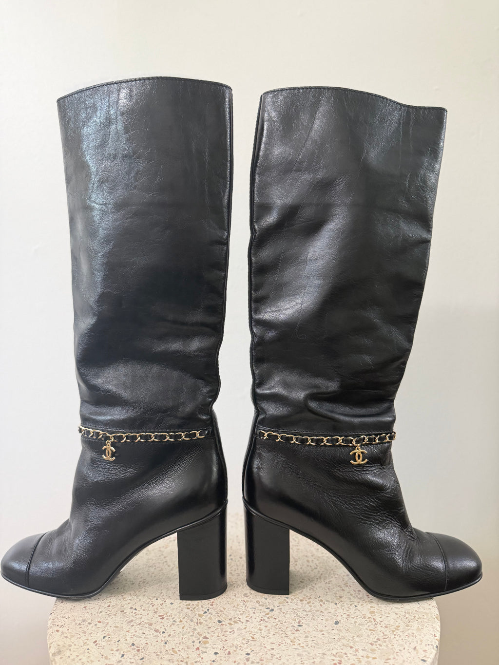 Chanel leather tall boots with a gold CC chain detail and block heel