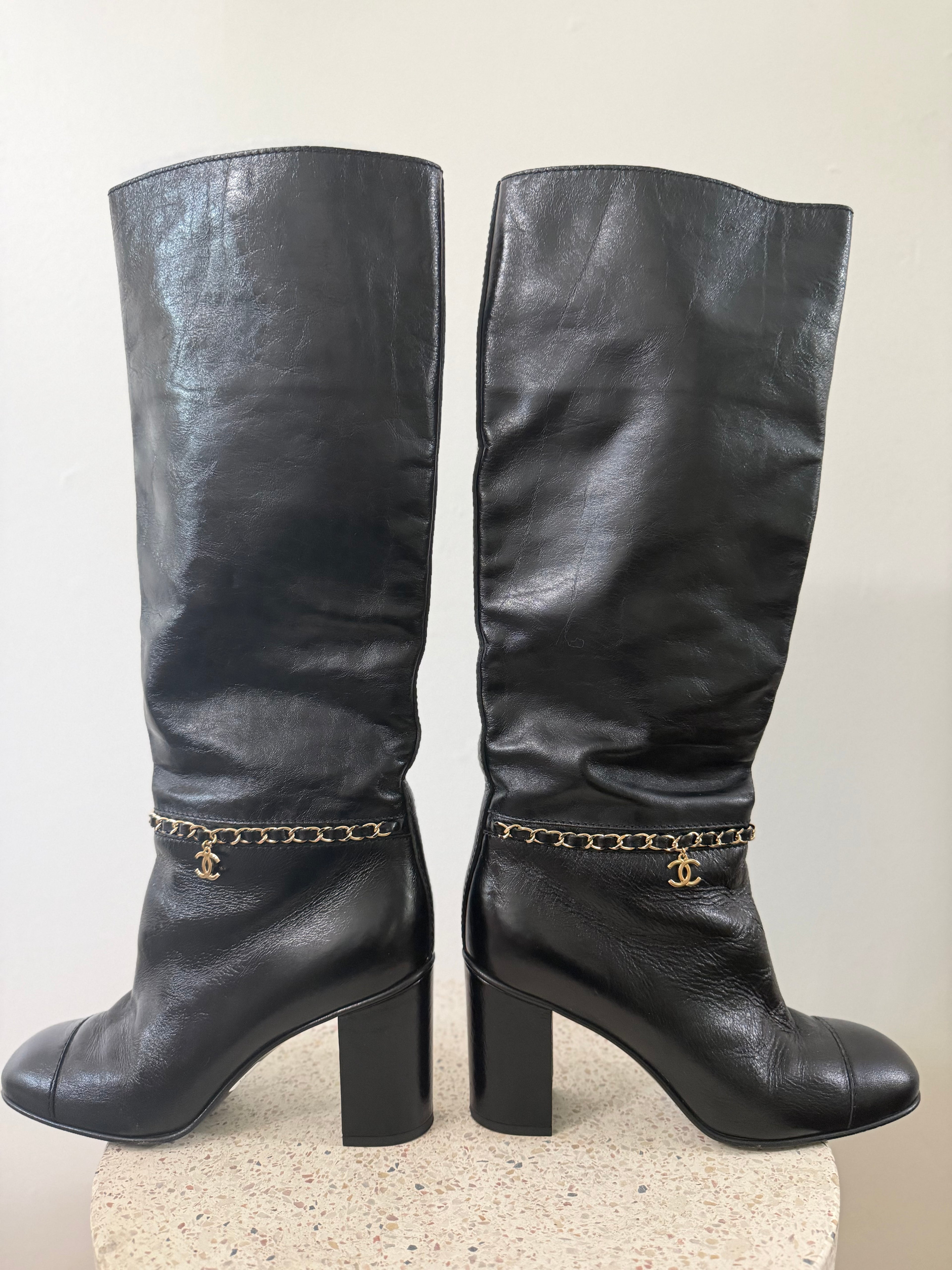 Chanel leather tall boots with a gold CC chain detail and block heel