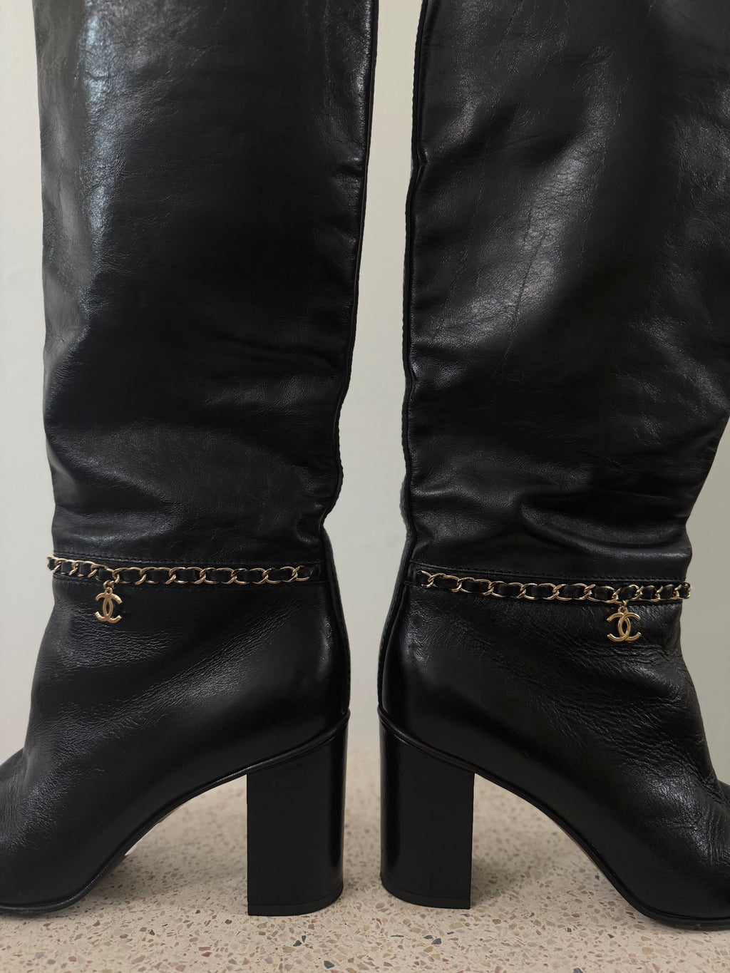 Chanel leather tall boots with a gold CC chain detail and block heel