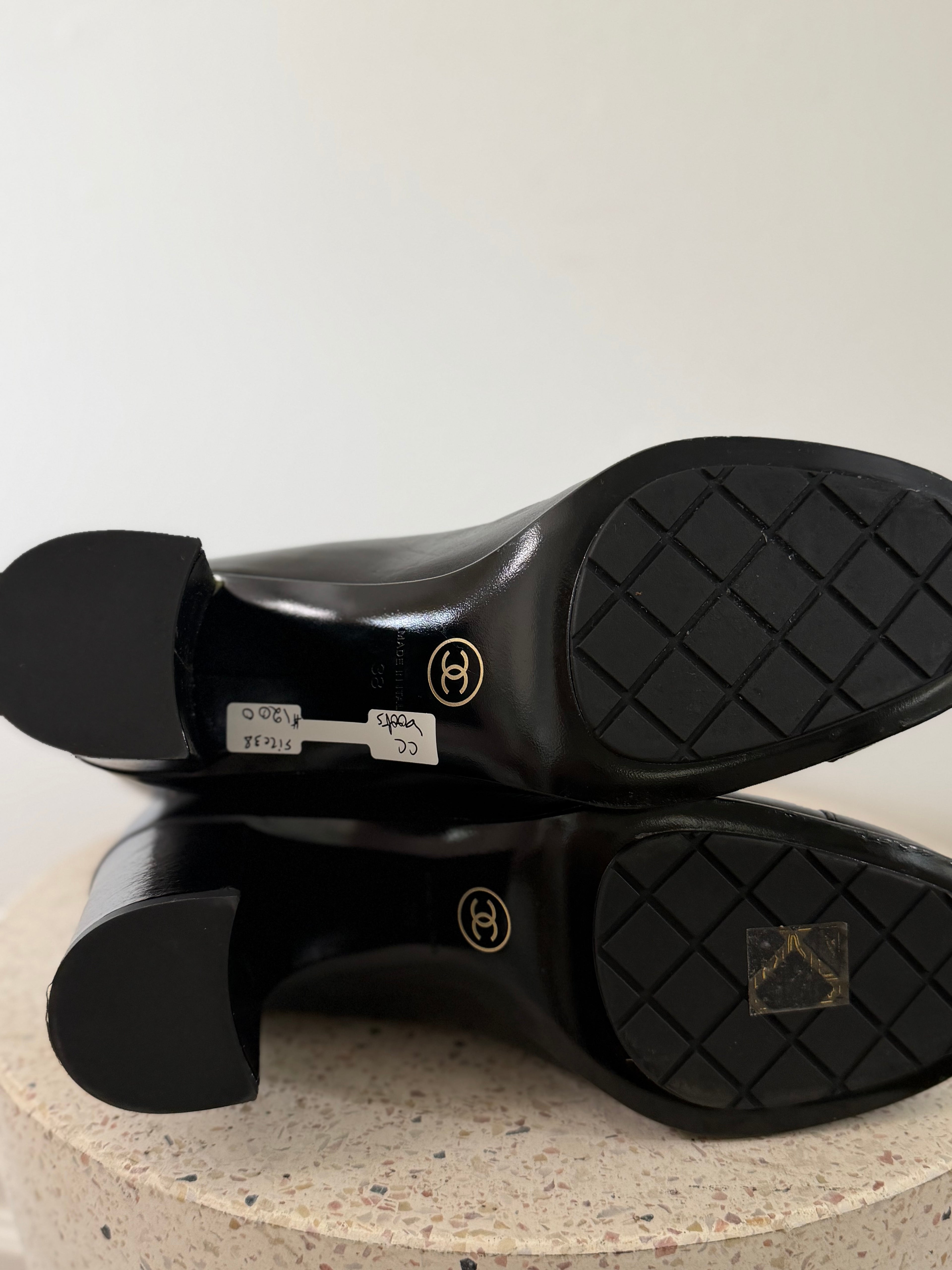 Chanel leather tall boots with a gold CC chain detail and block heel