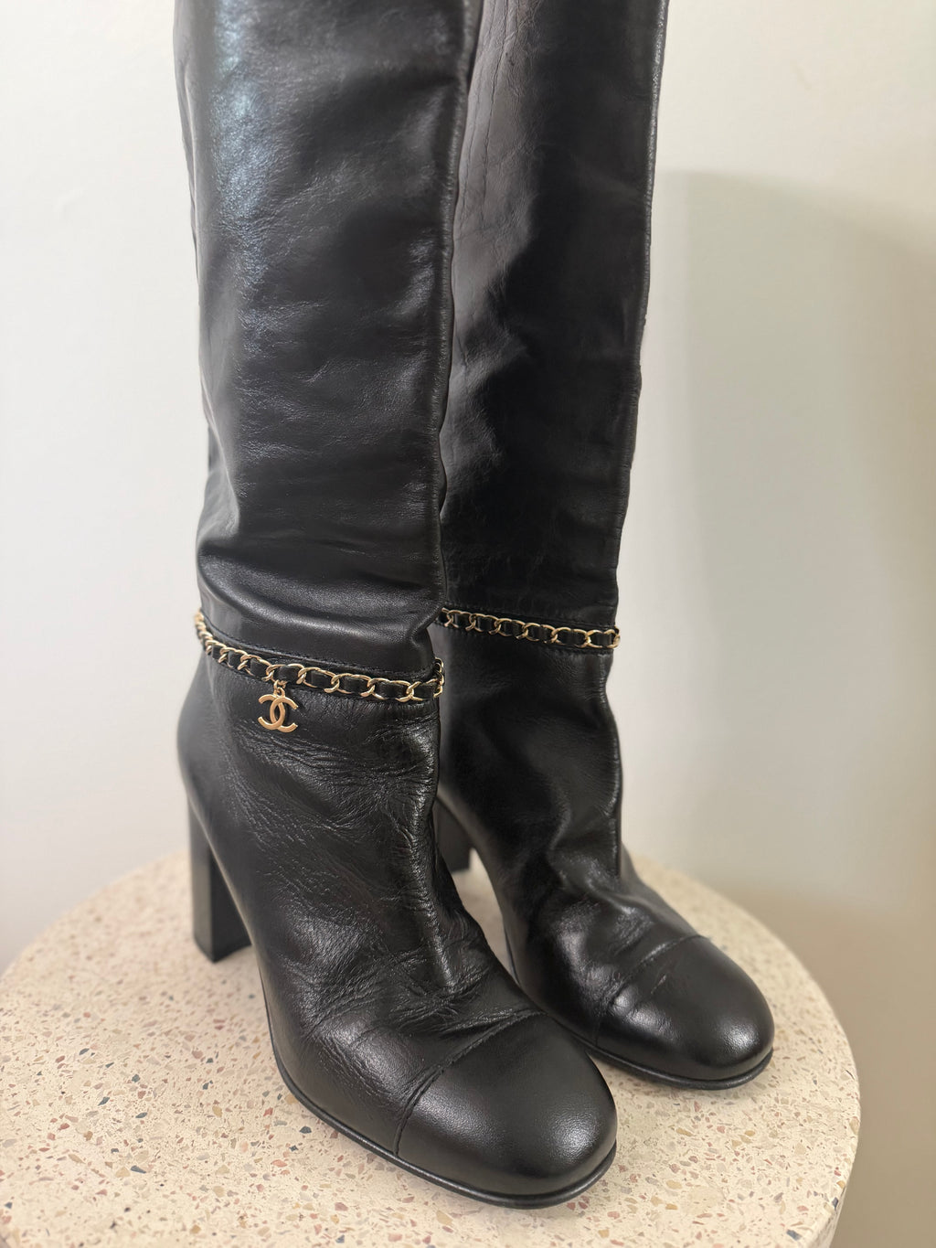 Chanel leather tall boots with a gold CC chain detail and block heel