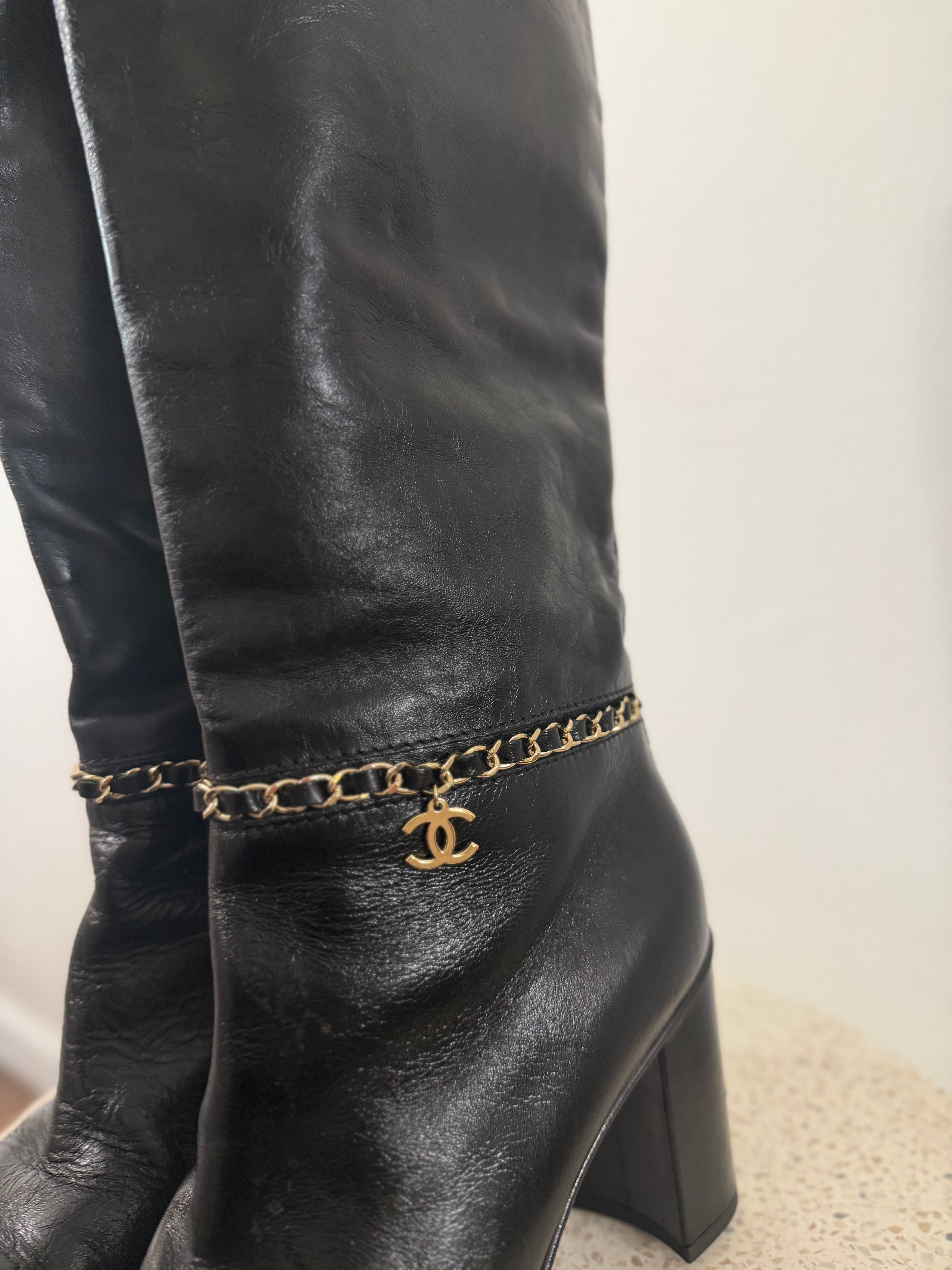 Chanel leather tall boots with a gold CC chain detail and block heel