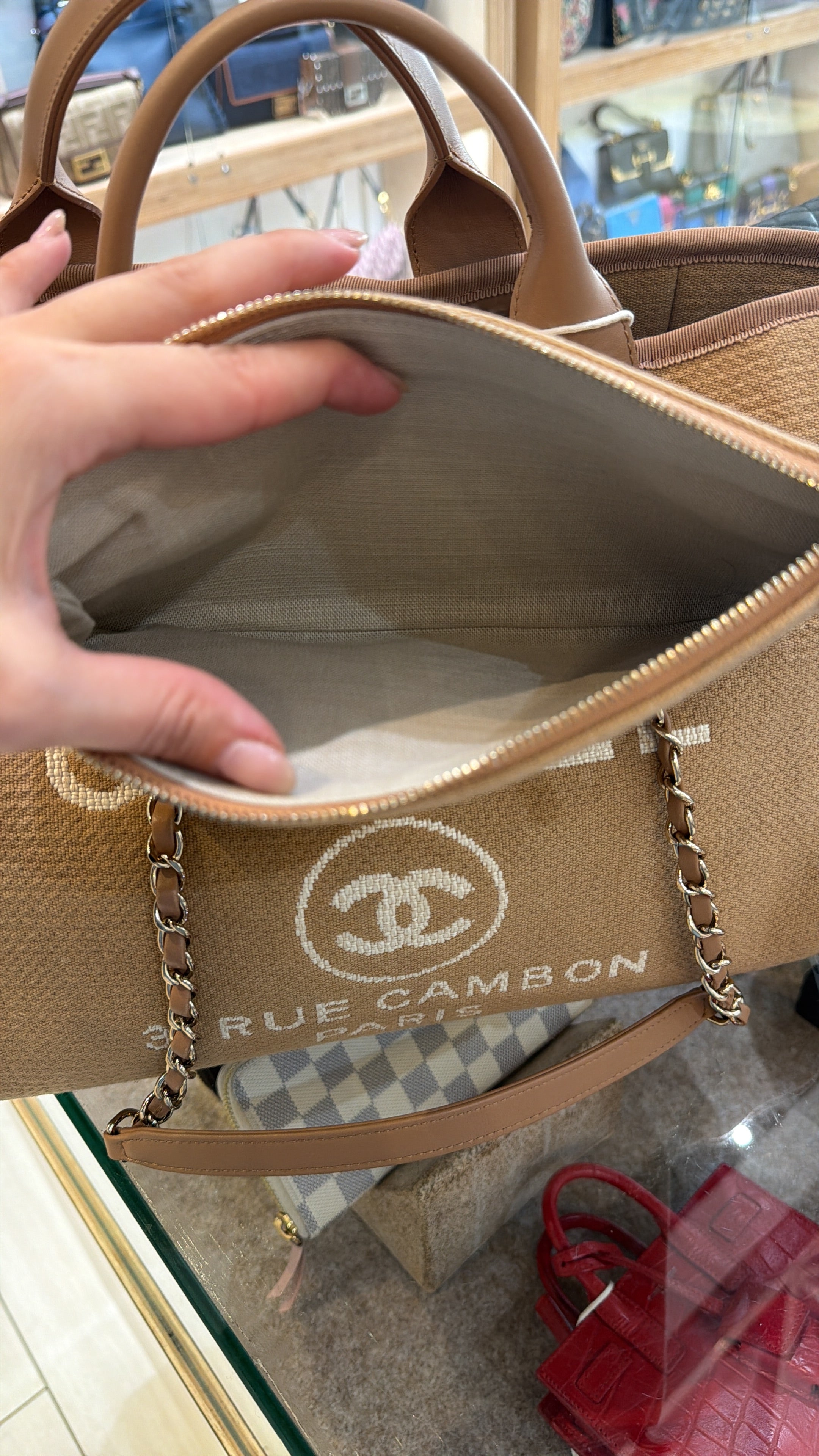 Chanel Medium Deauville tote bag in mixed fibers with gold-tone chain and leather handles