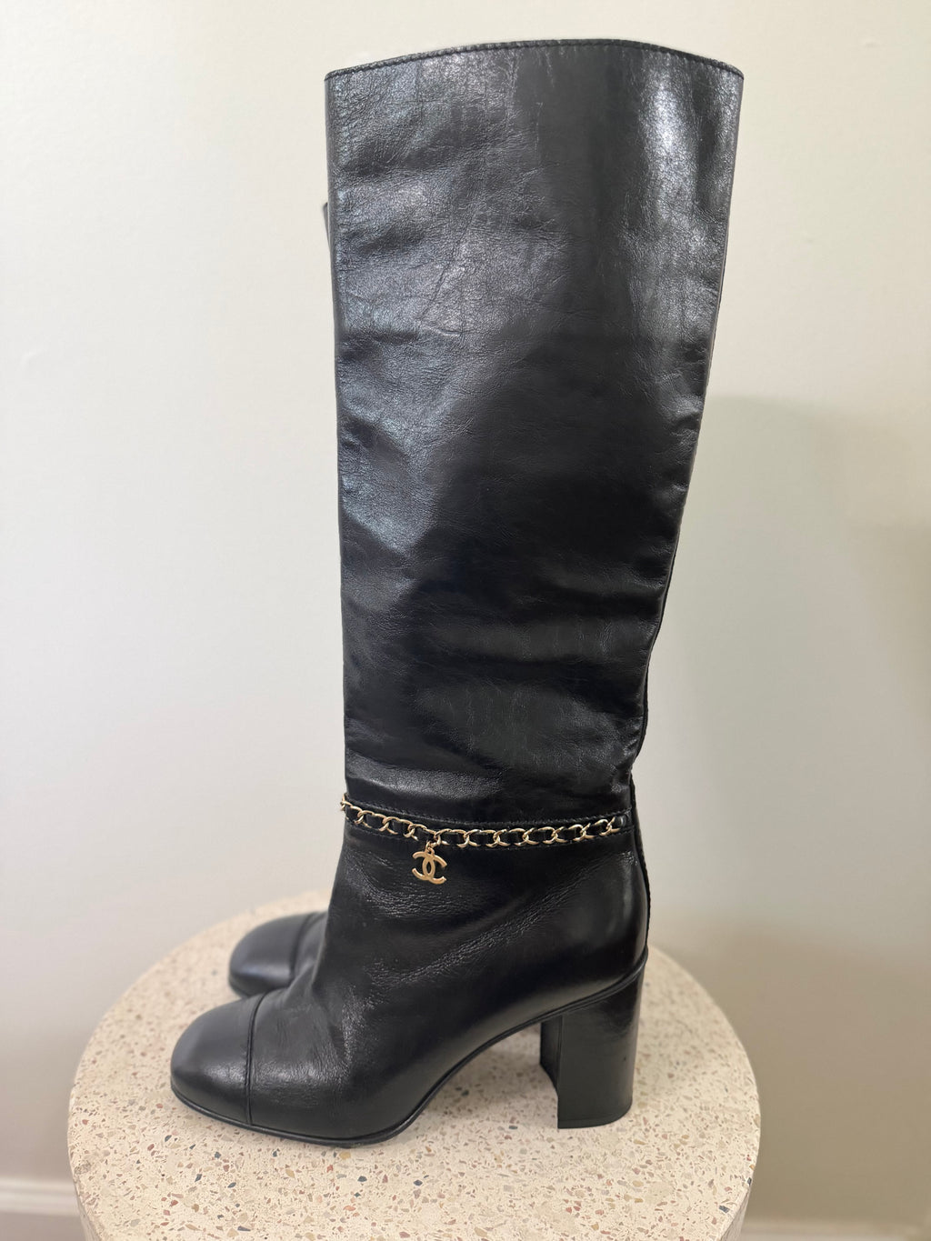 Chanel leather tall boots with a gold CC chain detail and block heel